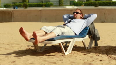 businessman-relaxing-on-sunbed-on-the-beach