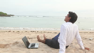 happy-businessman-relaxing-at-beach-while-summer-holiday